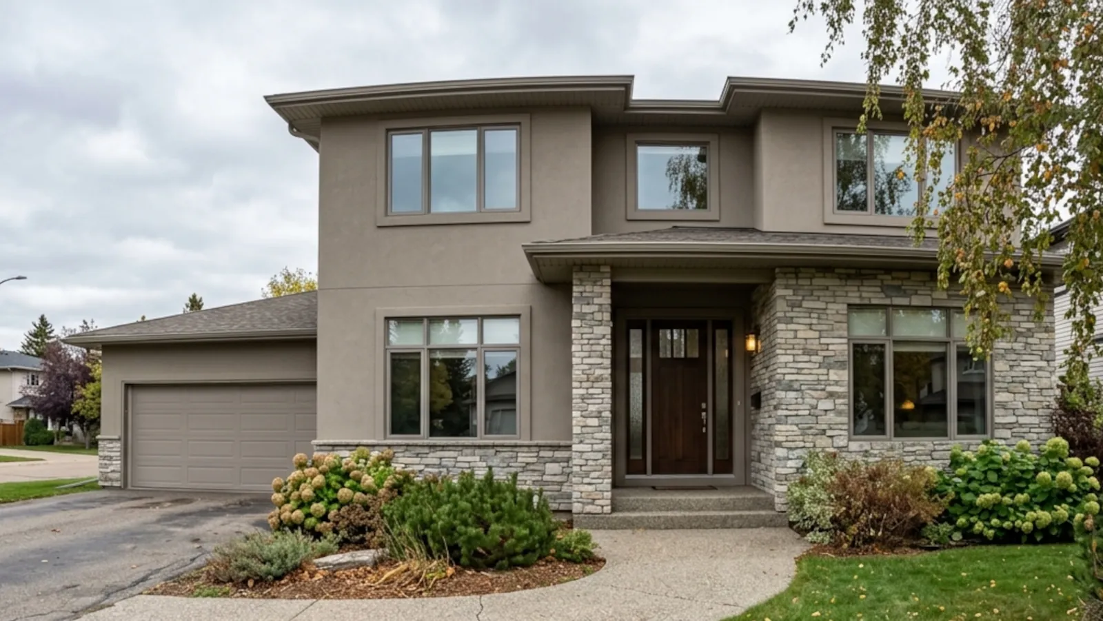 Modern Edmonton home exterior with partial stone veneer accent wall integrated into stucco finish