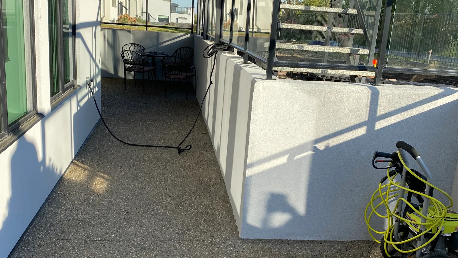 Acrylic parging applied to a concrete retaining wall in Edmonton with a smooth modern finish