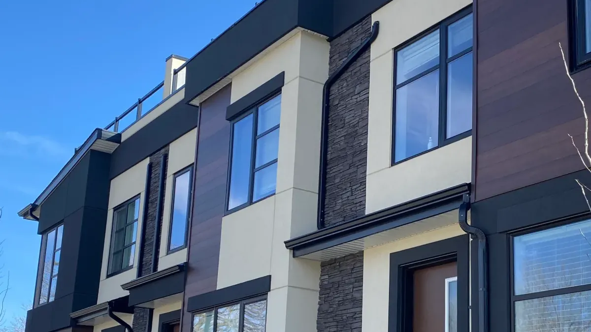 Close-up detail of charcoal stacked stone veneer with clean stucco transitions