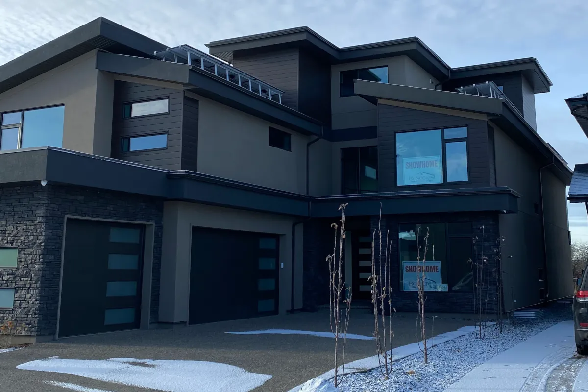 Custom multi-tone acrylic stucco and EIFS exterior installation on a luxury home in Edmonton.