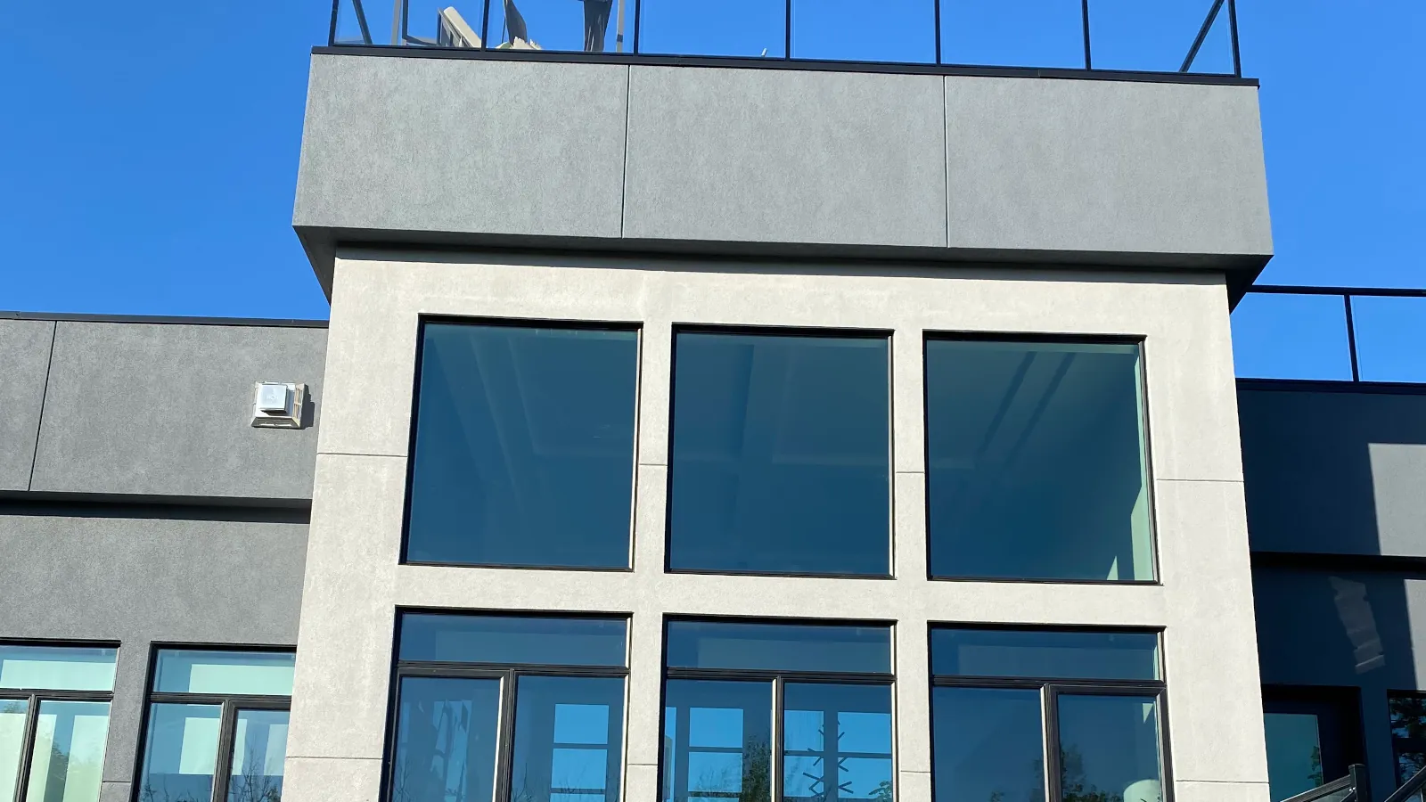 High-performance EIFS installation with a smooth grey finish on a modern exterior in Edmonton by AxisLayer Exteriors.